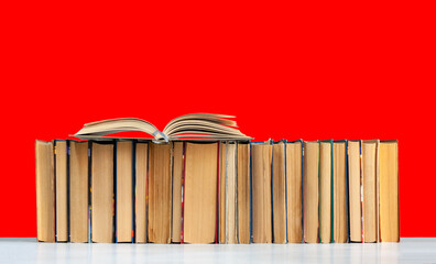 Back to school, pile of books with red background. Distance home education. Quarantine concept of stay home