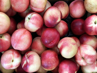 Fresh organic white peaches at a farm market stand displayed for sale 