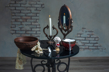 soft shaving brush with bowls and metallic safety razor with mirror and candle on table in barber shop 