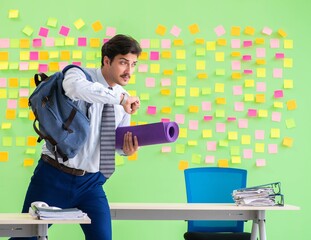 Man in the office with many conflicting priorities preparing go