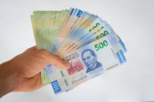 Hand giving mexican pesos money papers