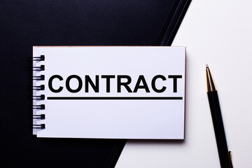 The word CONTRACT is written on a black and white background near the pen. Business concept