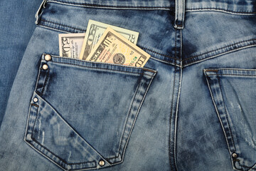 US dollar banknotes in jeans back pocket