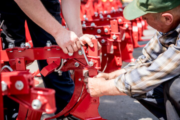 The mechanics repair combine harvester. Modern agricultural machinery