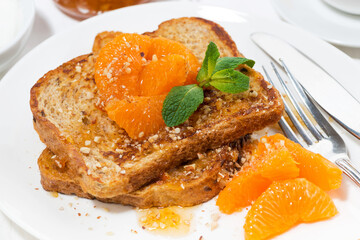 sweet french toast with jam and tangerines for breakfast, closeup