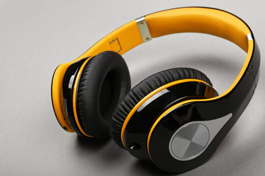 Close Up Modern Yellow Headphones On Gray Table