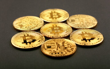 Gold bitcoin physical coins over black