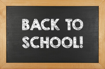 Back to school chalk sign over black chalkboard