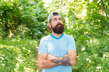 Naklejka na ściany i meble Away From City. man hipster hiking. male beard care. brutal hipster in forest. discover new places. time for picnic. daydreaming guy with moustache. mature bearded man in cap. summer camping vacation