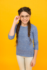 Adorable nerd. Schoolgirl concept. Smart girl bad eyesight. Let me see. Reading better with eyeglasses. Eyeglasses for eyes health. Clever girl. Girl school pupil wear eyeglasses yellow background