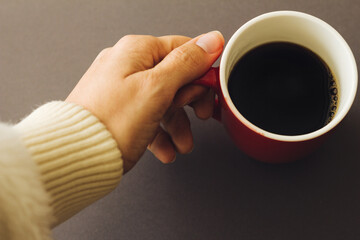  hand holding red coffee cup