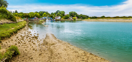 A panorama view down the River Ouse towards the village of Piddinghoe, UK in summer © Nicola