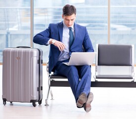 Businessman waiting at the airport for his plane in business cla