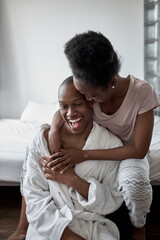 portrait of happy smiling married african couple in the morning at home, man and woman happy together, they are in love. posing at camera