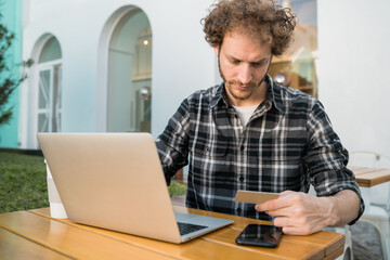 Man using laptop to shop online.