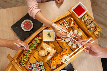 Family sharing a sushi boat platter in restaurant