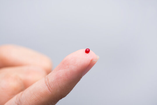 Blood drop on fingertip prepare for checking the glucose level with a glucometer for examining diabetes mellitus.