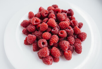 Red raspberry berries close-up on a white background. Healthy food, natural vitamins. Fresh berries