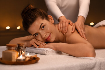 Happy girl enjoying aromatherapy and healing massage at spa