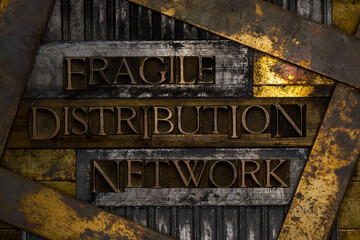 Fragile Distribution Network text formed with real authentic typeset letters on vintage textured silver grunge copper and gold background
