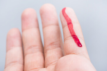 Bleeding blood from the cut finger wound. Injured finger with bleeding open cut wound. Closeup of...