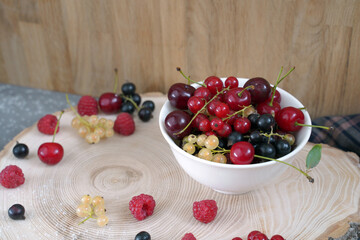 fresh berries in a bowl on a wooden table