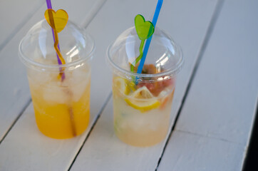 Two glasses of cold summer drinks. Glasses with mojito on a white wooden table. Summer concept. Cold detox water with ice.