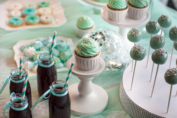 Children's holiday table. Birthday decoration. Table with cakes and sweets for children. Table with...