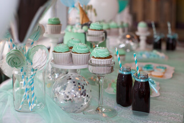 Children's holiday table. Birthday decoration. Table with cakes and sweets for children. Table with sweets for the holiday.