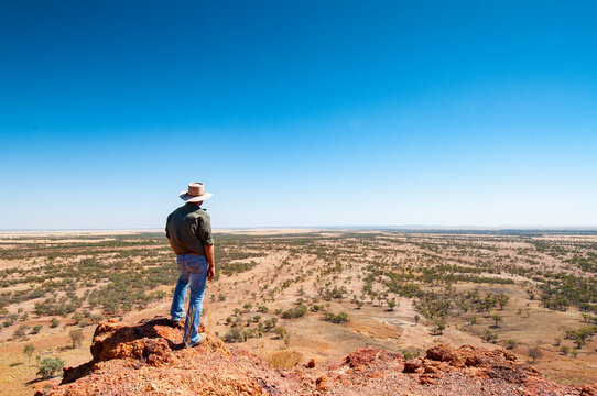 rancher looking out on Outback landscape, Queensland, Australia