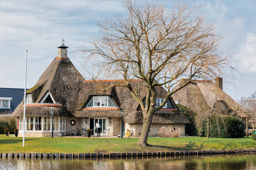 Fototapeta na wymiar Modern thatched house in Hindeloopen, Netherlands, Europe