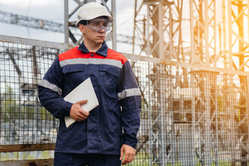 The energy engineer inspects the equipment of the substation. Power engineering. Industry