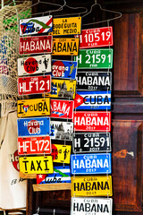 HAVANA, CUBA - NOVEMBER 17, 2017: Colorful souvenir license plates on a display. They are a popular items for sale as souvenirs and can be bought in many stores or markets in Havana, Trinidad.