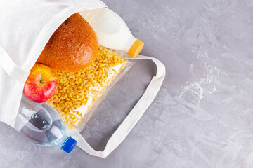 Food donations in linen bag. Food delivery in eco bag. Eco bag with food supplies food stock. Top view. Copy space