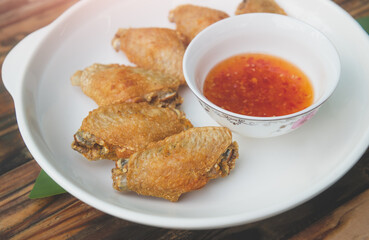 Frying salt chicken wing  serve in white plate.