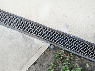 Fototapeta premium Drainage system outdoors. Metal grates for water drainage. Rain drain.