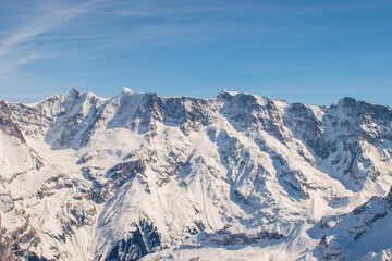 Beautiful panoramic view of snow-capped mountains in the Swiss Alps.