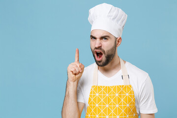 Angry young bearded male chef or cook baker man in apron white t-shirt toque chefs hat isolated on...