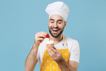 Funny young bearded male chef or cook baker man in apron white t-shirt toque chefs hat isolated on...