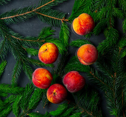Obraz premium group of peaches with leaves and Christmas tree branches