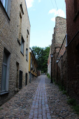 Fototapeta na wymiar The narrow passage that goes up. Street of the quiet center of Riga, Latvia.