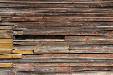 Weathered wood panels with damaged parts.