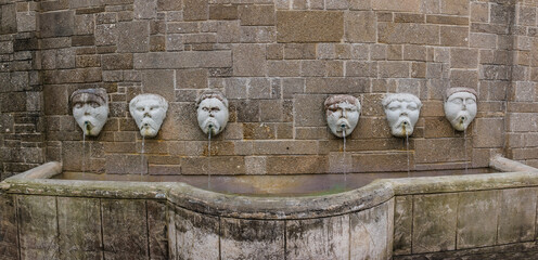 Water Pouring From Sculpted Faces in City Park,St. Augustine,Florida,USA