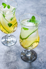 Elderflower and apple juice mocktail with cucumber, mint and ice cubes