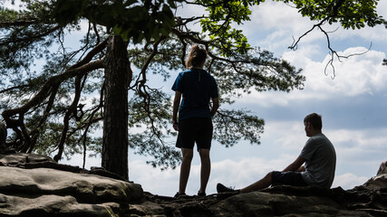 Silhouette of two teenager in the mountains