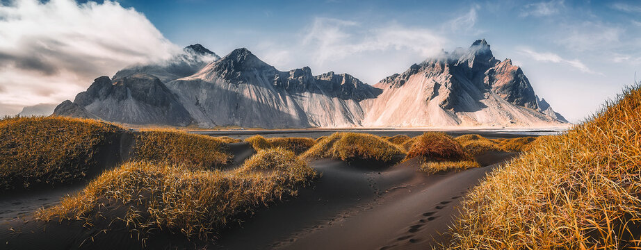 Fototapeta Vestrahorn mountaine on Stokksnes cape in Iceland during sunset. Amazing Iceland nature seascape. popular tourist attraction. Best famouse travel locations. Scenic Image of Iceland