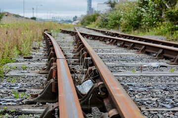Train tracks and rusty rails. Rarely used old train tracks leading to old deserted docklands in...