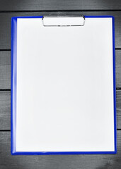 Empty clipboard on a wood table