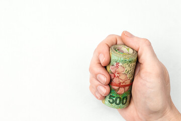 Argentine peso banknotes held by female hand 