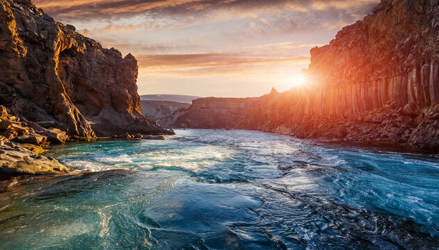 Scenic Image of nature of Iceland during sunset. Tipical icelandic landscape of summer. Majestic basalt canyon, powerful river and colorful sky. Iceland Best country for travel locations.